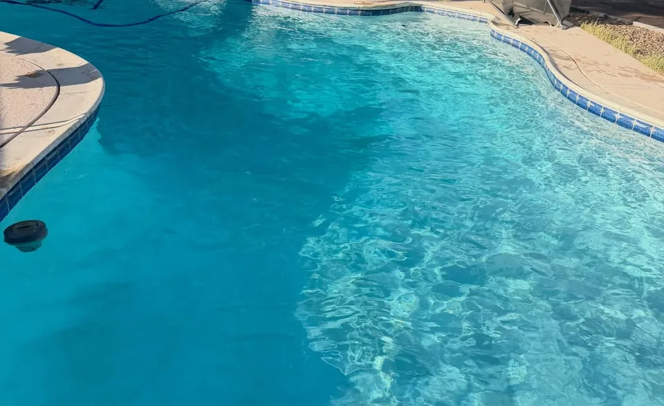 Clear blue pool water along a clean waterline tile band